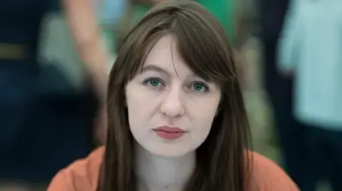 The acclaimed novelist claims she cannot travel to the UK due to legal concerns